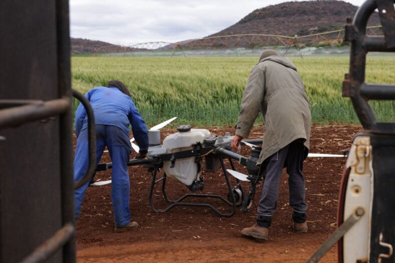 A drone equipped with lidar technology surveying a power line for inspection and security purposes.